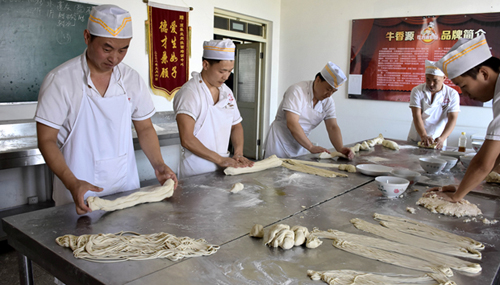 Students learning the art of noodle making at a local beef noodle school in Lanzhou 